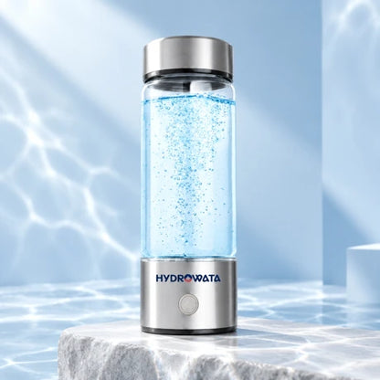 Hydrowata glass hydrogen water bottle on a pale stone plinth